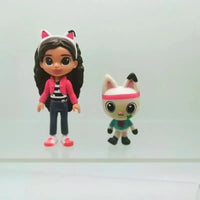 Toy doll and cat figurine on a white background