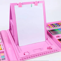 Pink children's drawing set with paper and crayons on a white background