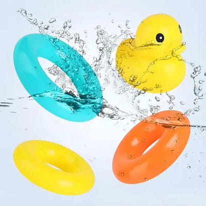 Colorful rubber duckies and rings splashing in water on a light blue background