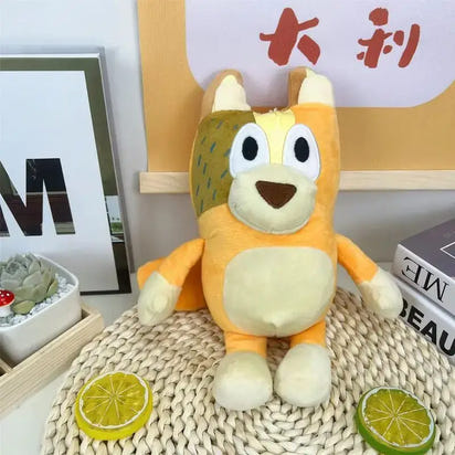 Plush toy resembling a fox with large eyes on a textured surface with decorative elements.