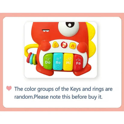 Colorful toy piano with text warning about random key color groups on a pink border.
