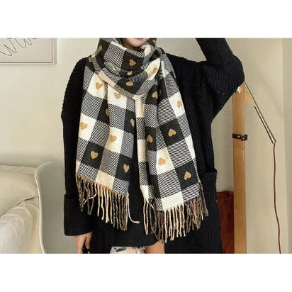 Woman wearing a black and white checkered scarf with heart patterns indoors.