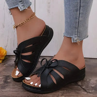 Black leather slide sandals.