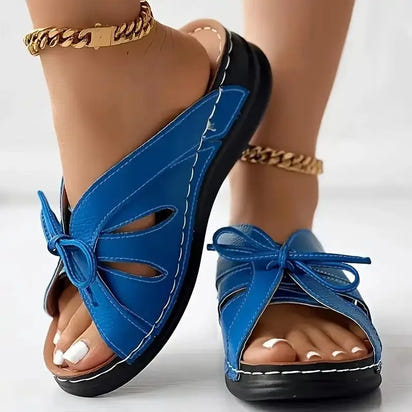 Blue leather sandals with ankle bracelets.