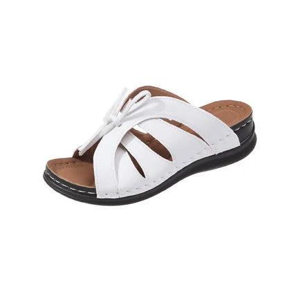 White leather sandal with crisscross straps.