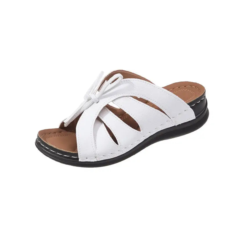 White leather sandal with crisscross straps.