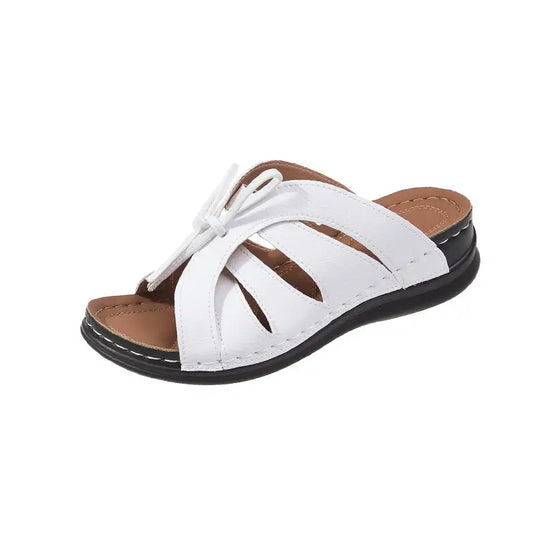 White leather sandal with crisscross straps.