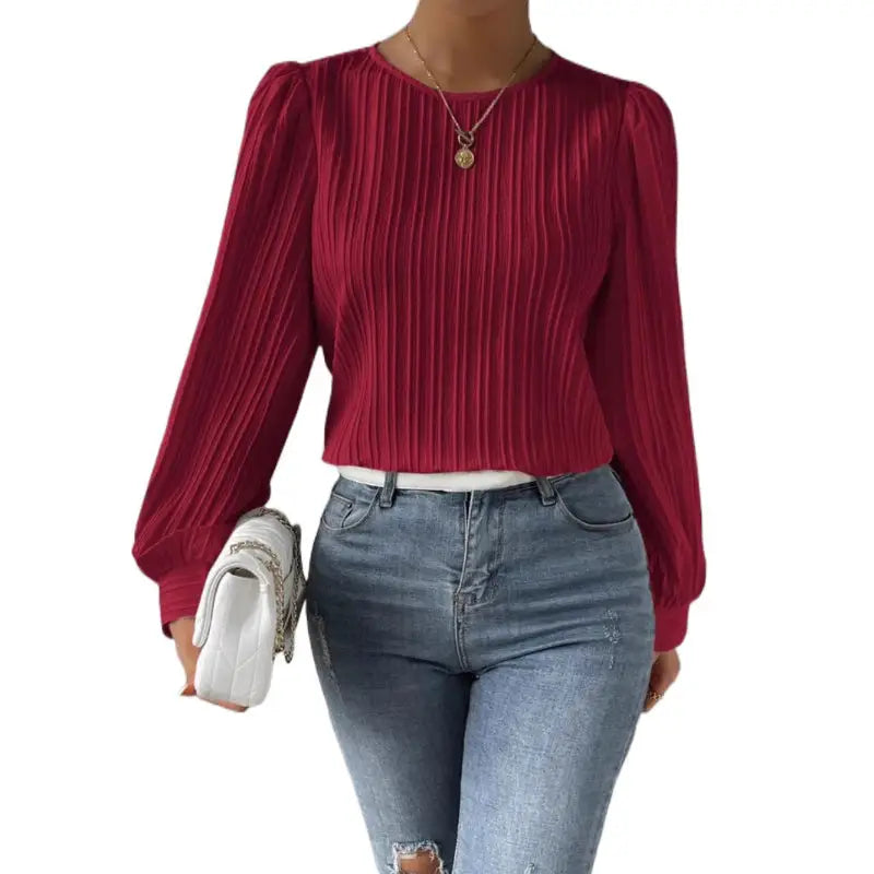 Burgundy pleated long-sleeve top.