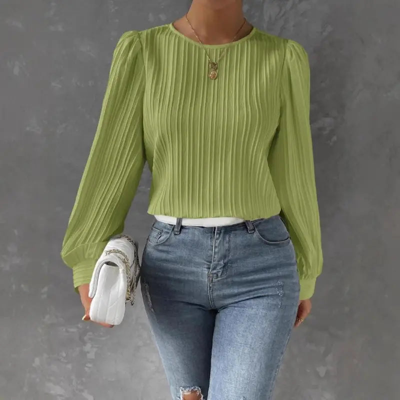 Green pleated long-sleeve blouse.