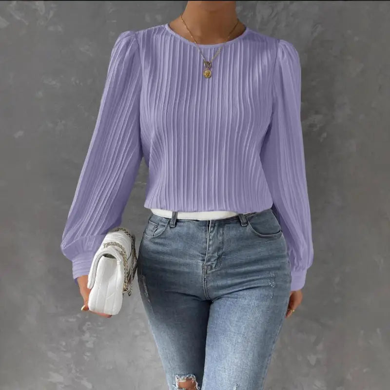 Woman’s lavender pleated blouse and jeans.