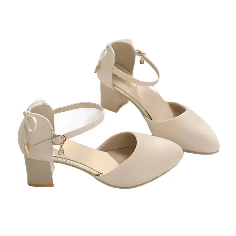 Beige ankle strap heels.
