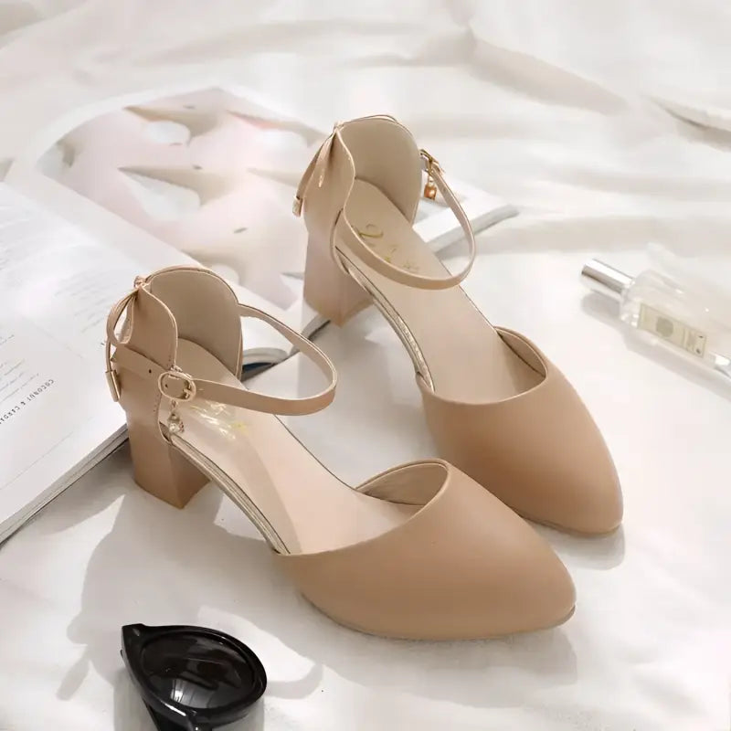 Beige ankle strap heels.