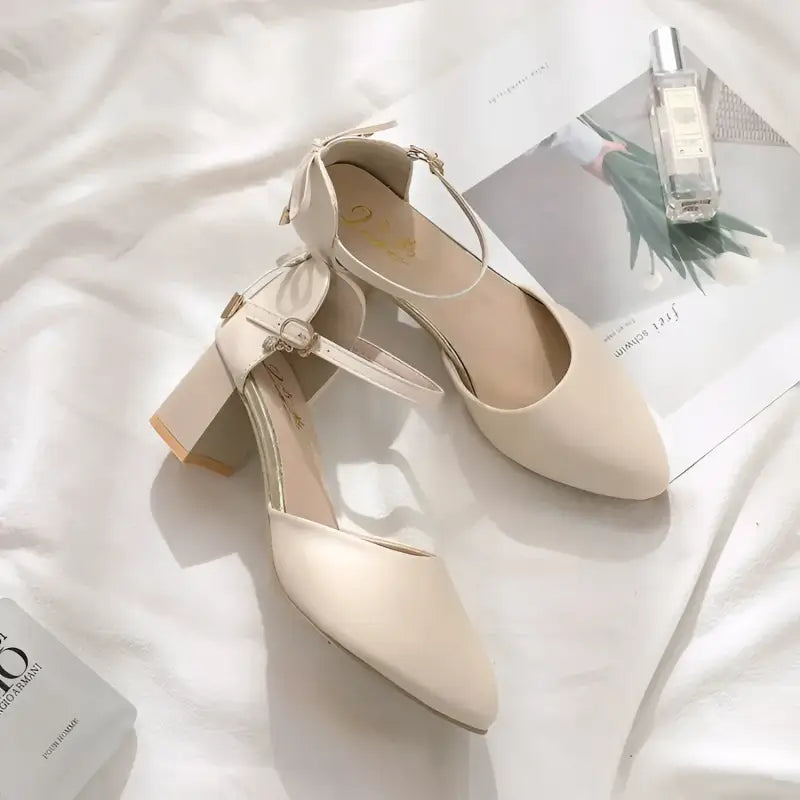 Beige ankle strap heels.