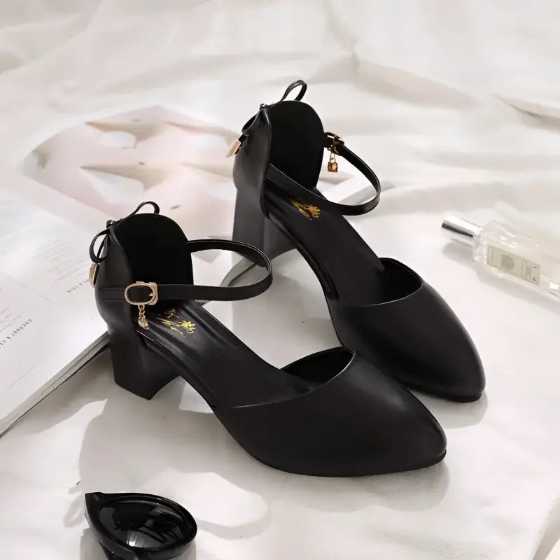 Pair of black, ankle-strap heels.