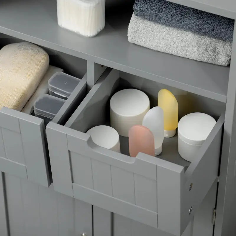 Gray bathroom cabinet with open drawers.