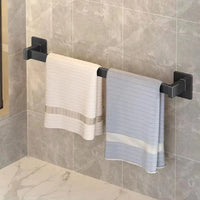 Black towel rack with towels.