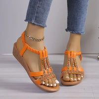 Orange jeweled T-strap sandals.