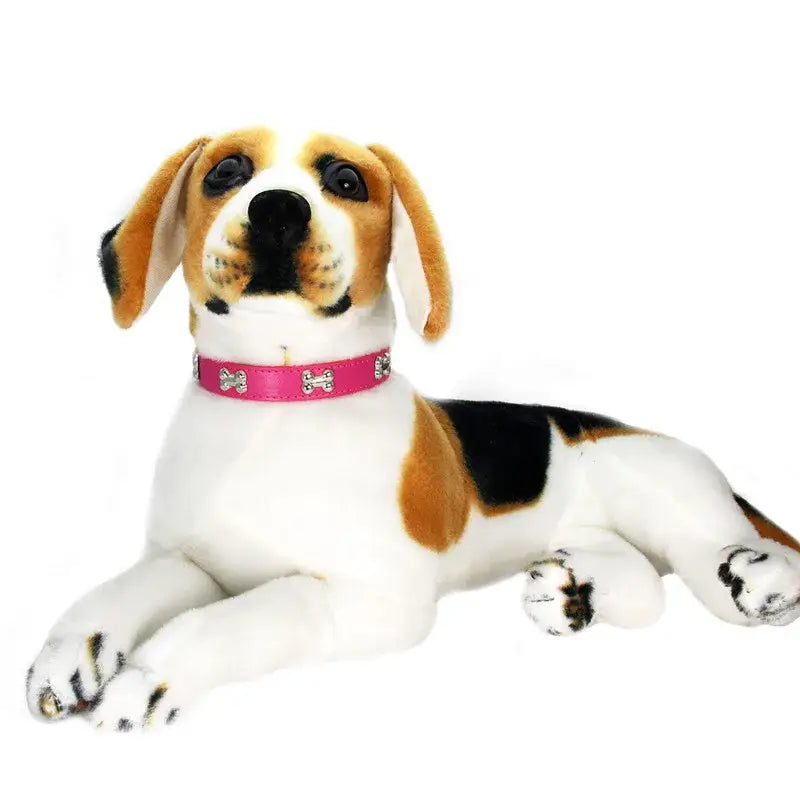 Stuffed beagle dog with pink collar.