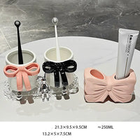 Bathroom accessory set with bow designs.
