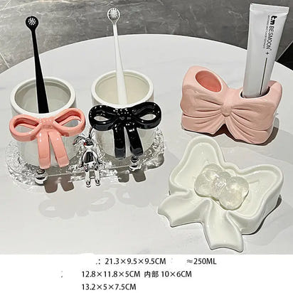Bathroom accessory set with bow designs.