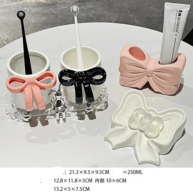 Bathroom accessory set with bow designs.