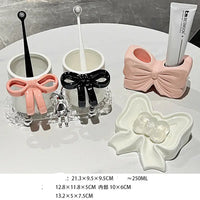 Bathroom accessory set with bow designs.