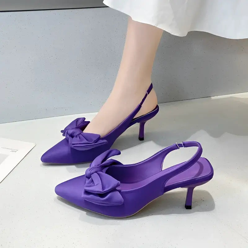 Purple satin bow slingback heels.