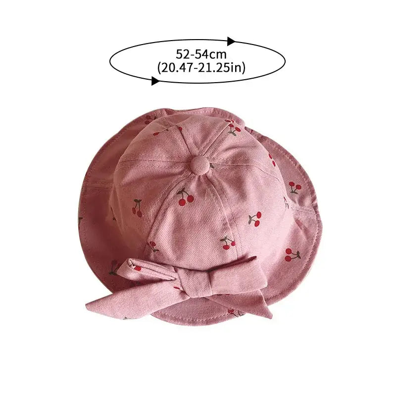 Pink cherry-patterned baby sun hat with bow.