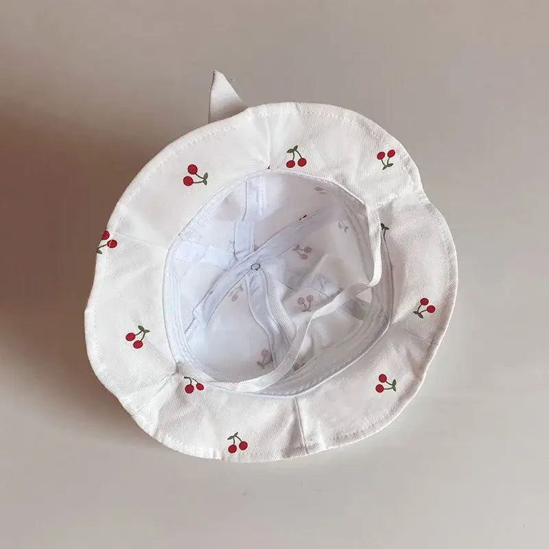 White cherry-patterned sun hat.