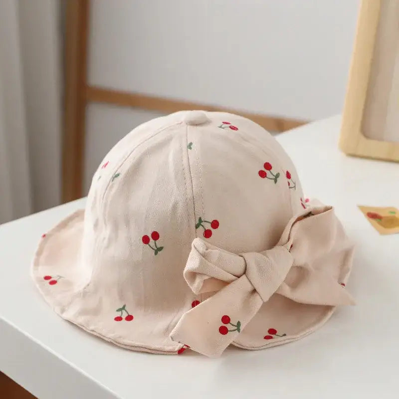 Cherry-patterned sun hat with bow.