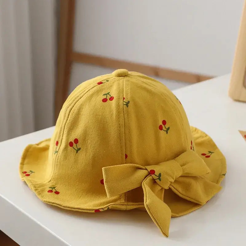Yellow cherry-patterned sun hat with bow.