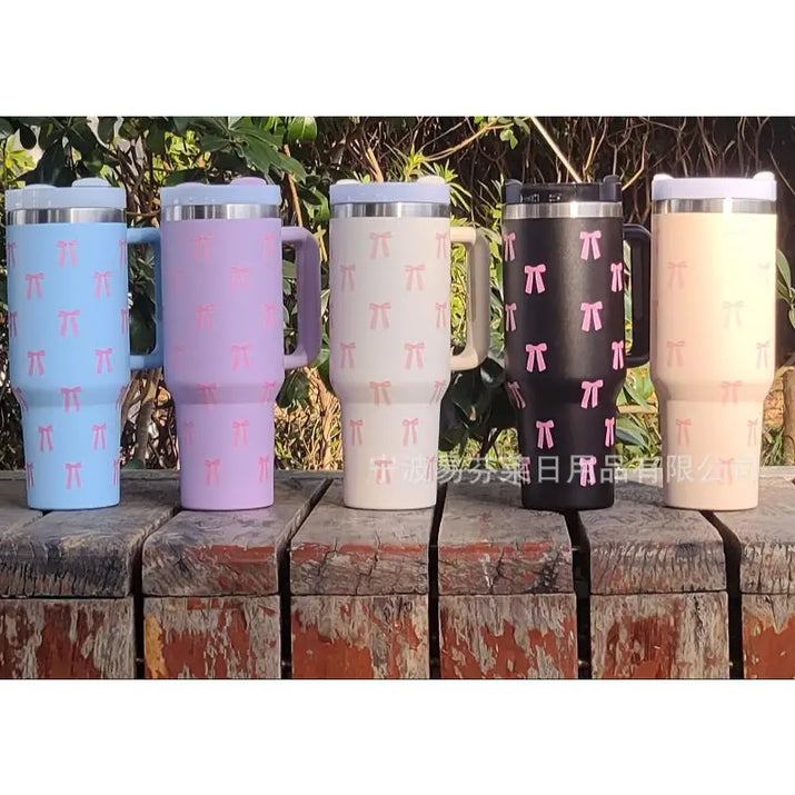Pastel-colored tumblers with bow pattern.