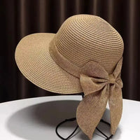 Tan straw sun hat with bow.