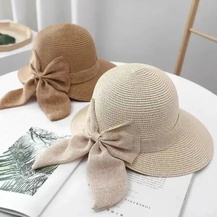 Two straw sun hats with bow accents.