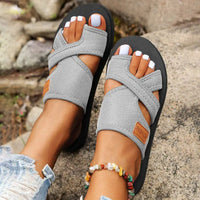 Gray crisscross toe-loop sandals.