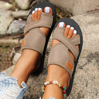 Beige toe-separator sandals.