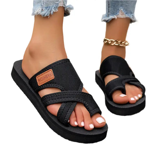 Black crisscross toe-ring sandals.