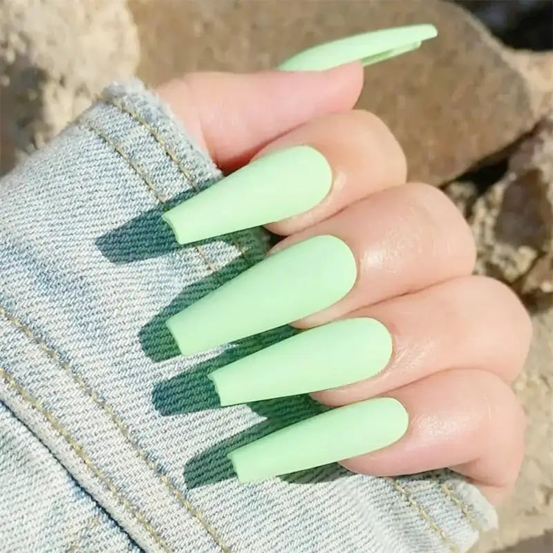 Long, matte, light green nails.