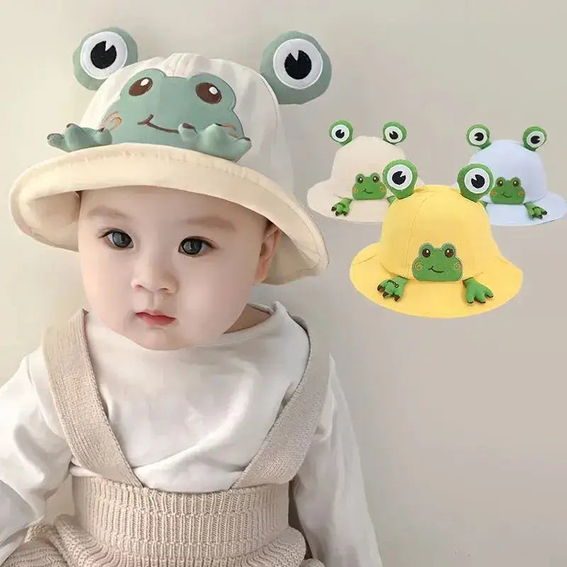 Baby wearing a frog-themed hat.