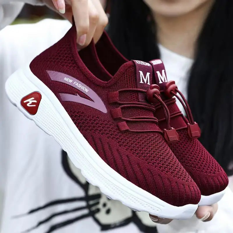 Maroon knit sneakers with white soles.