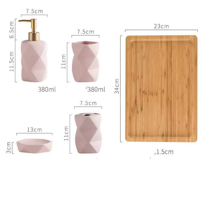 Pink bathroom accessory set with wooden tray.