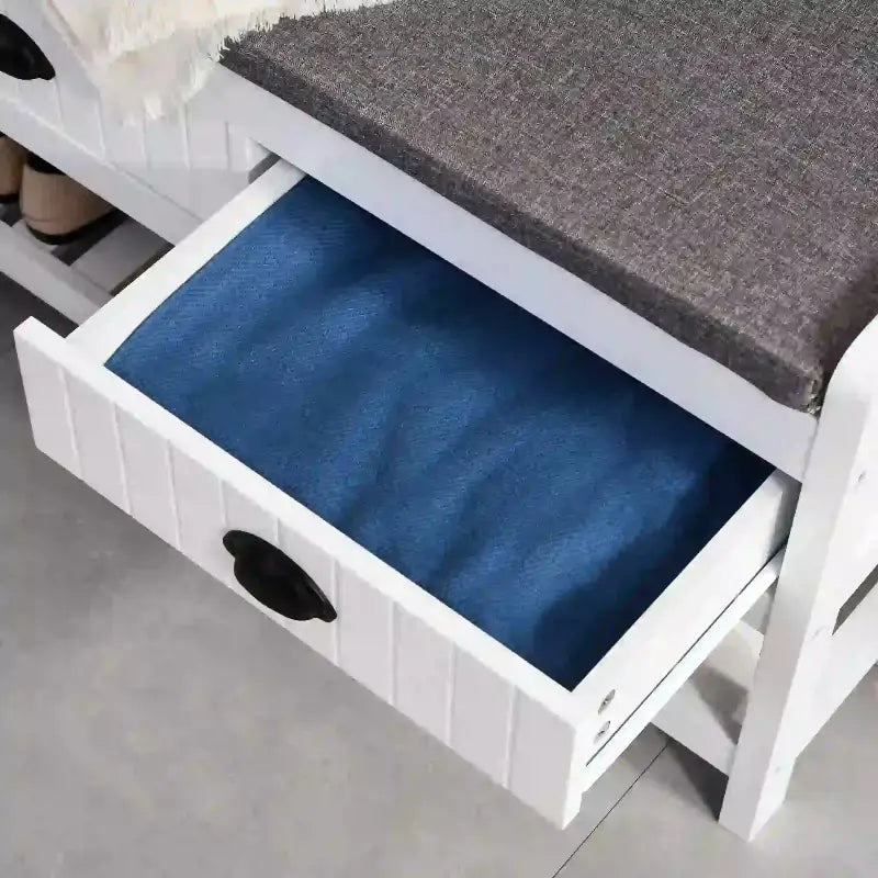 White storage bench with open drawer in a multifunctional coat rack shoe bench setup