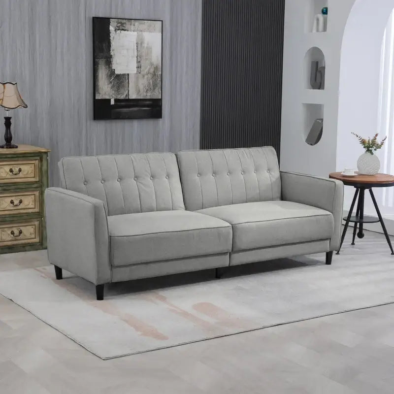Gray tufted sofa.
