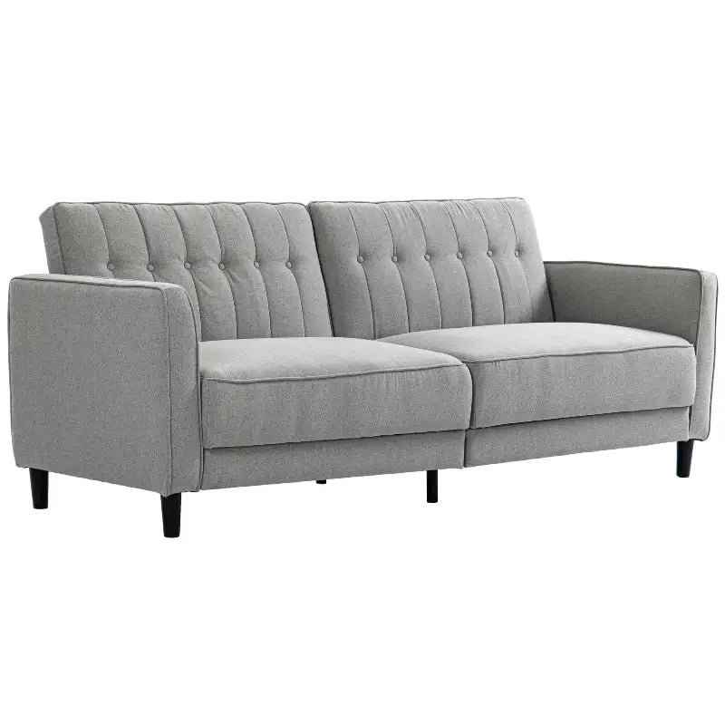 Gray upholstered sofa with button tufting.