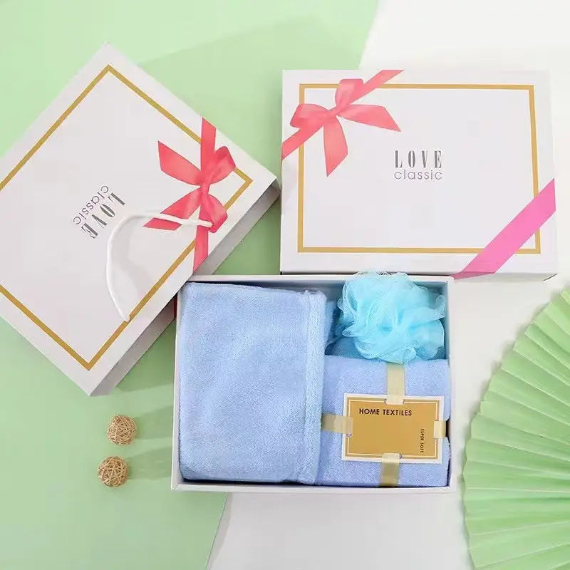 Gift boxes with towels and a bath sponge.