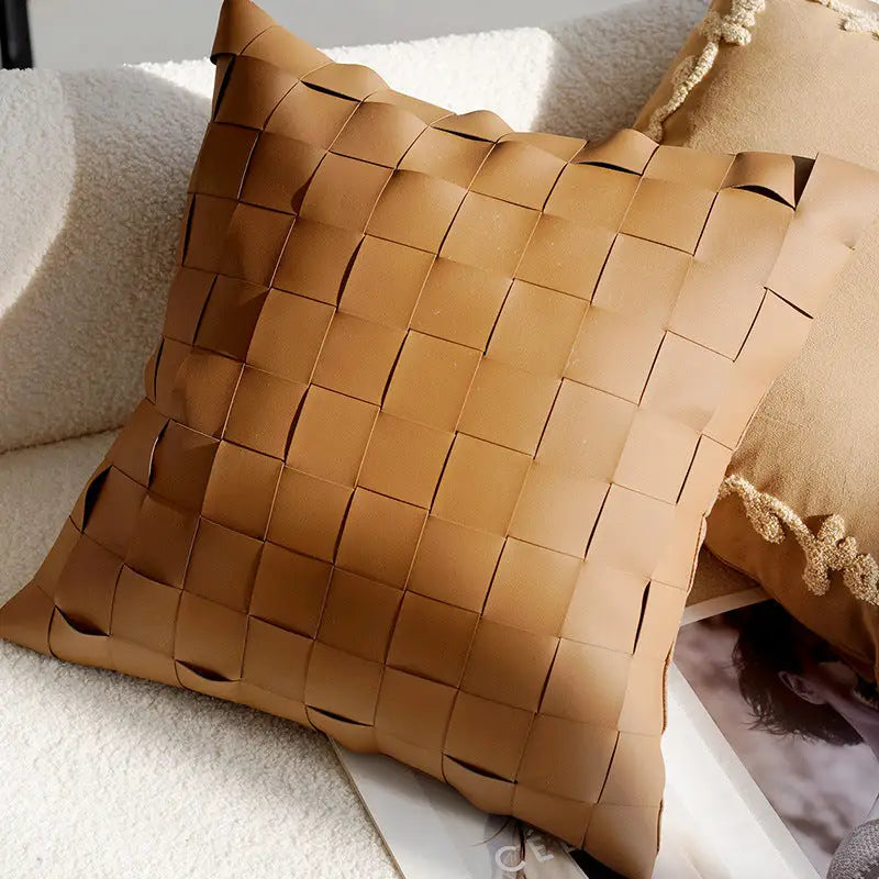 Woven tan leather pillow.