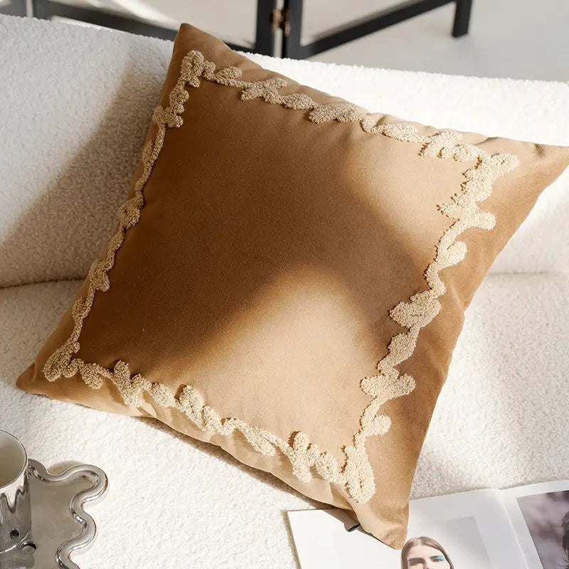Tan pillow with decorative trim.