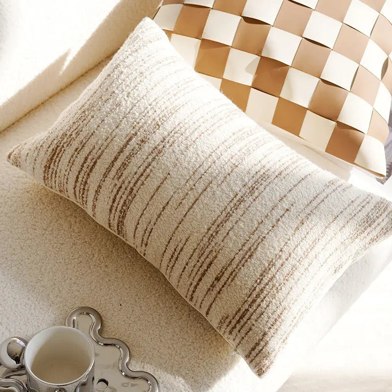 Textured lumbar pillow with brown stripes.