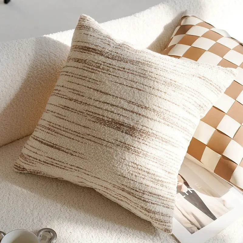 Textured beige pillow with brown stripes.