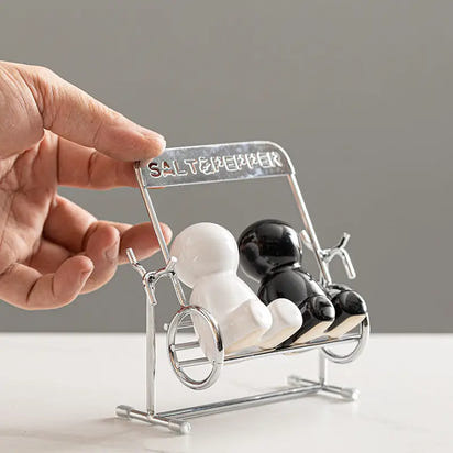 Creative black and white people salt shaker set with salt and pepper shakers on a swing